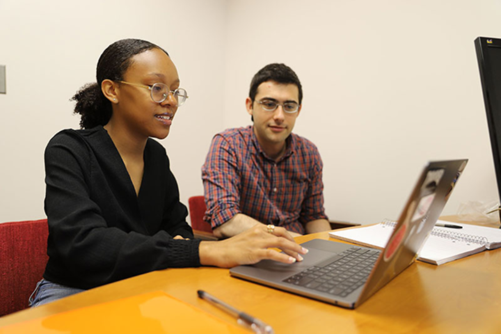 Students collaborating over a laptop
