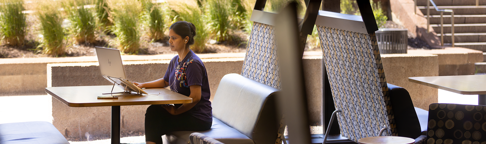 Student working outside in a courtyard